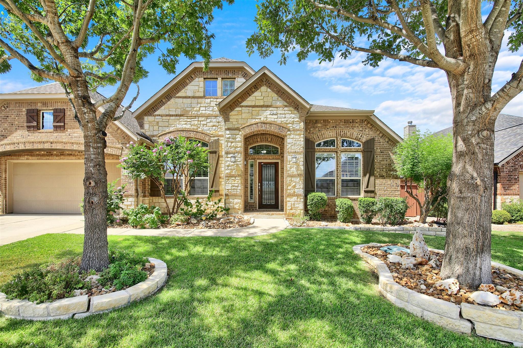 Mature trees shade a beautifully detailed stone a