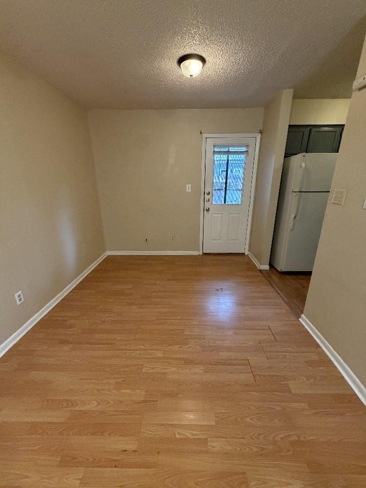 Smooth wood floors and a glass-paneled door highl