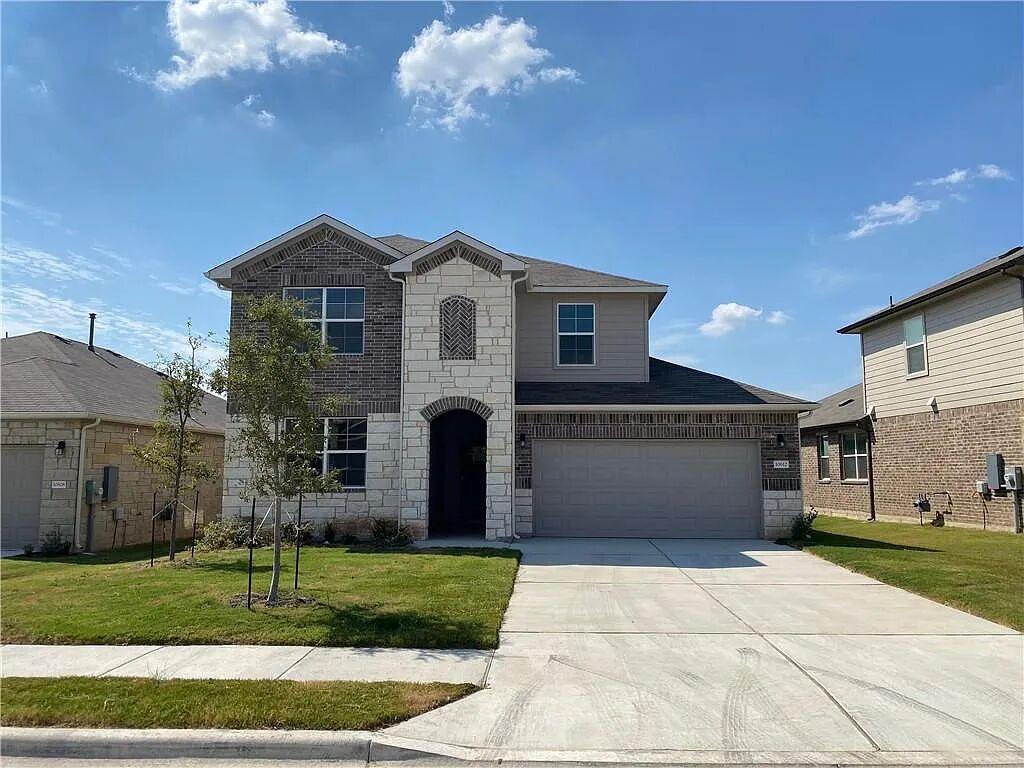 An attractive stone and brick exterior pairs with