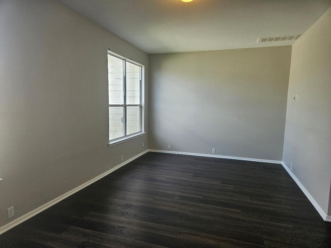 Rich dark wood flooring anchors this versatile sp