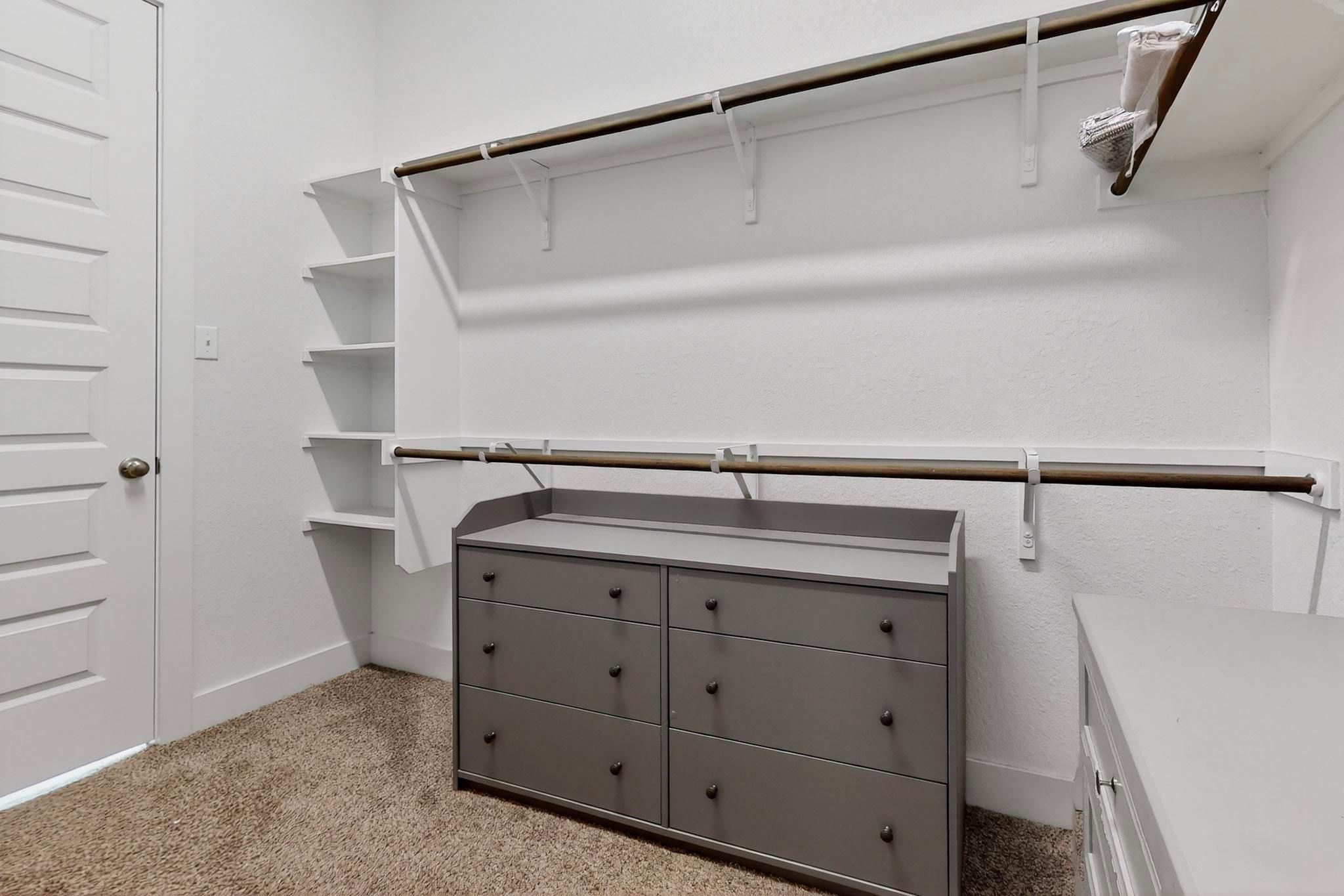 Ample built-in shelving and hanging rods maximize