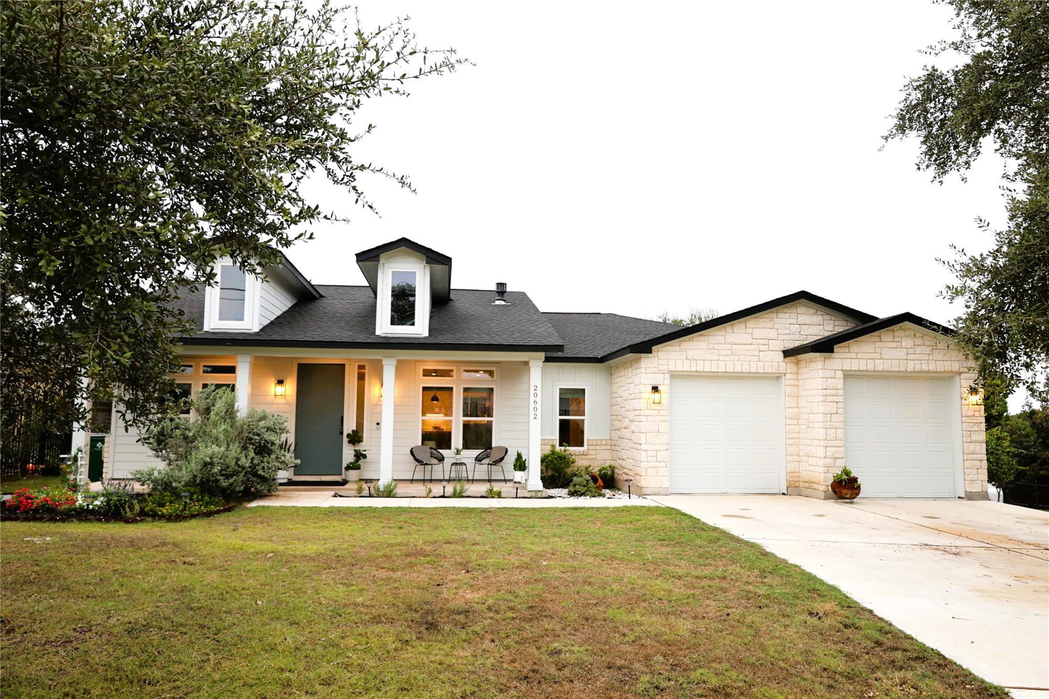 A classic front facade features stone accents, a 