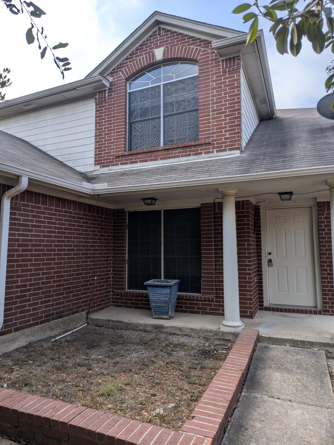 Classical columns support the covered entryway of