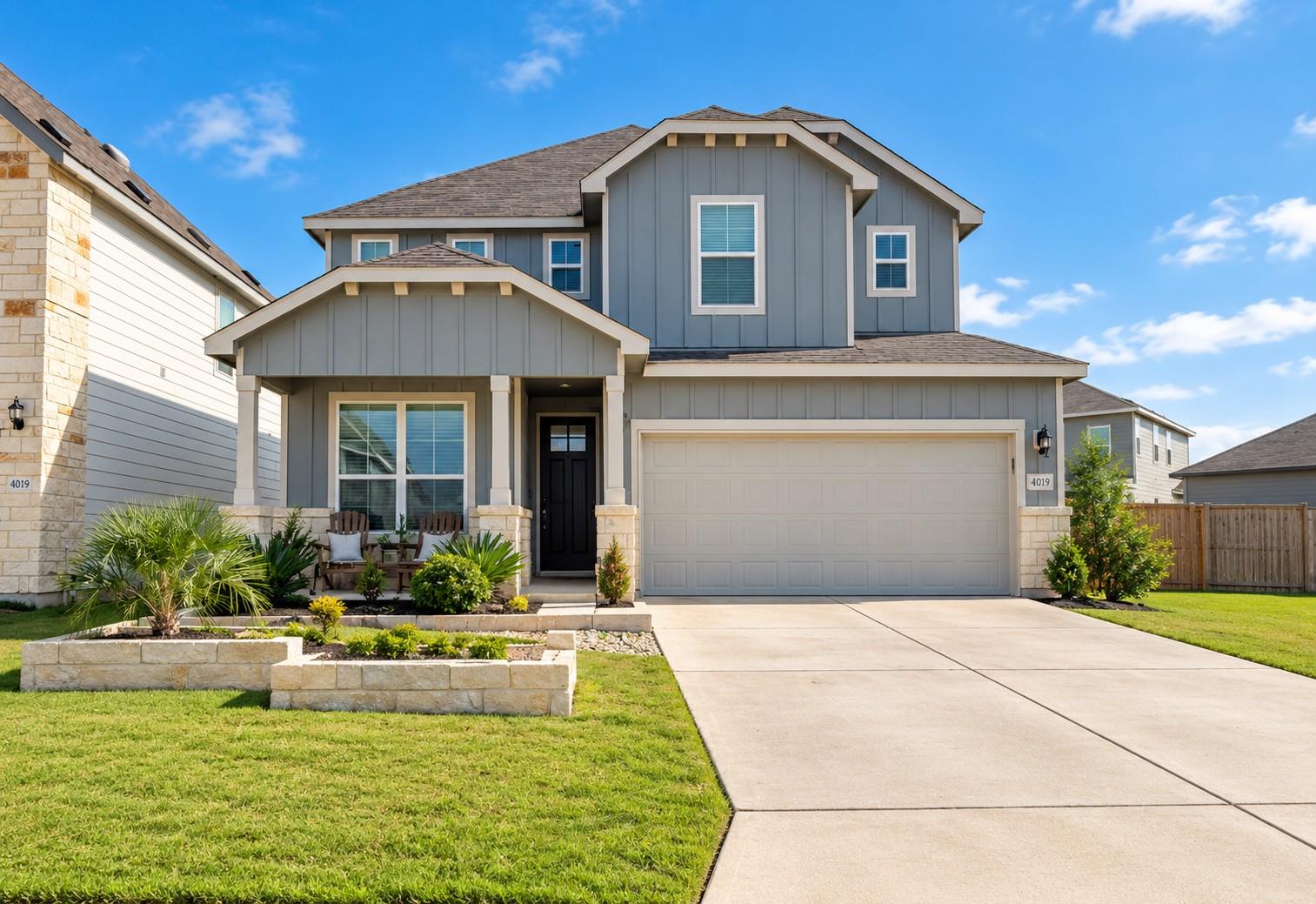 A spacious driveway leads to this modern two-stor