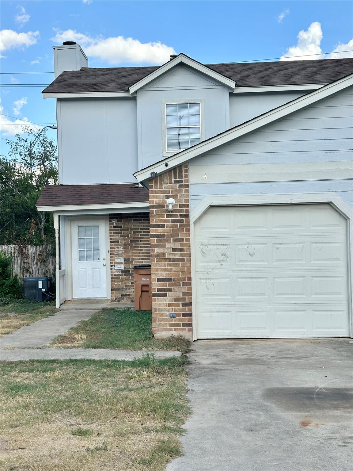 Brick and siding accents define the exterior of t