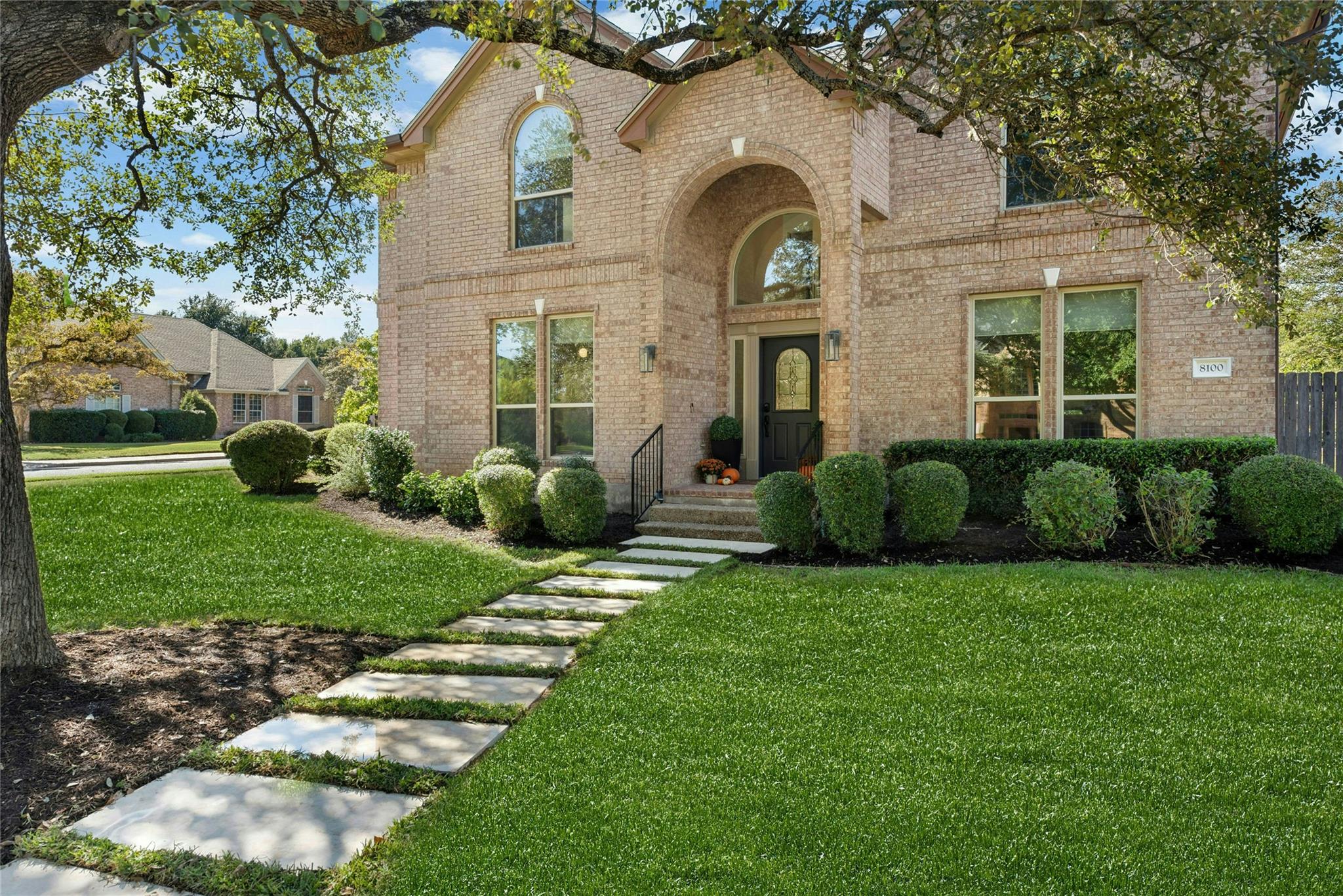A classic brick exterior with an arched entryway 