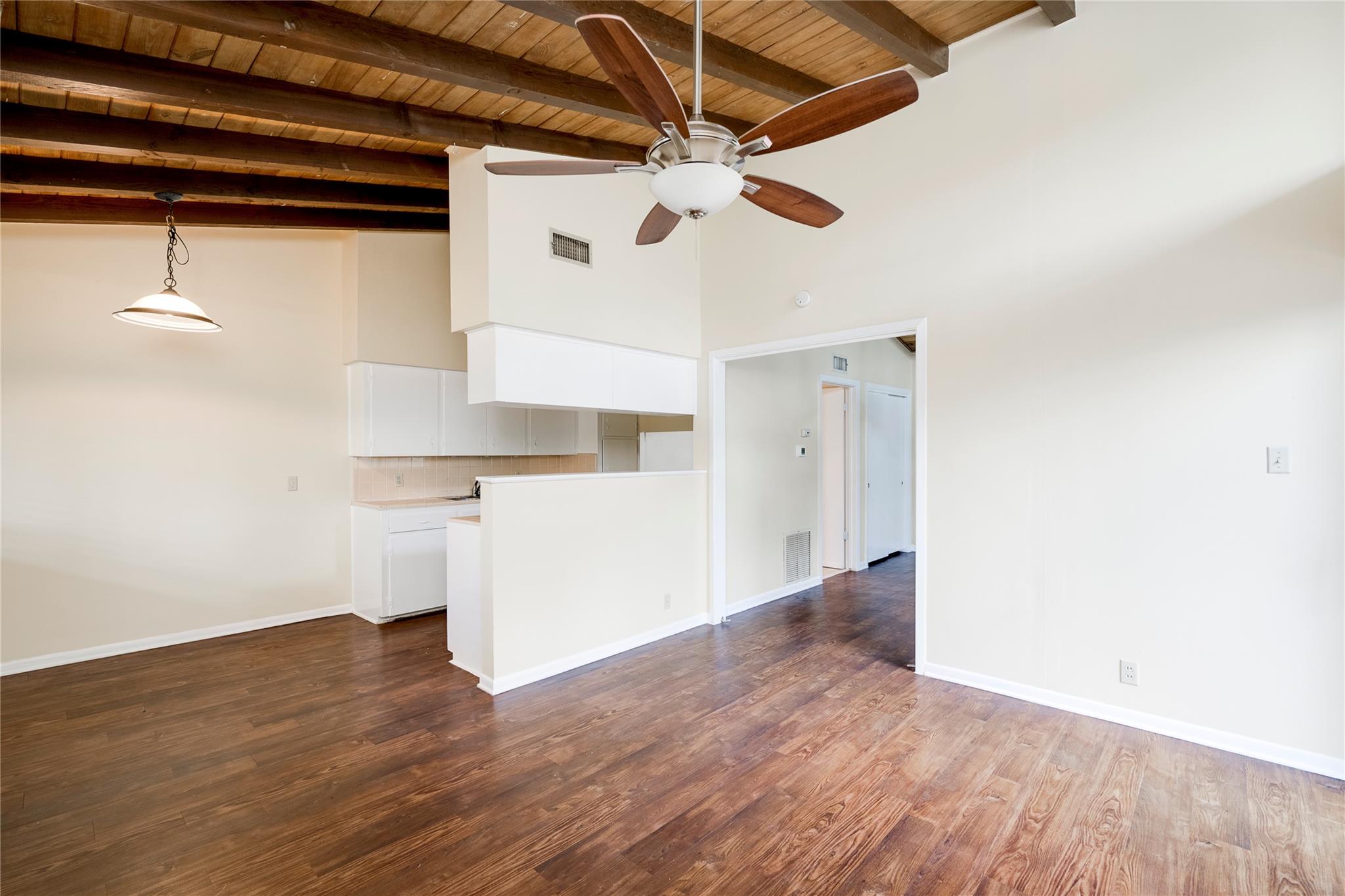 Rich wood flooring runs beneath vaulted ceilings 