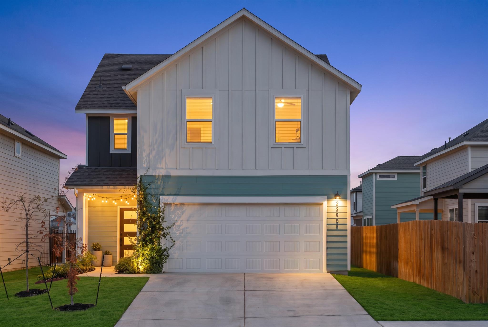 Modern vertical siding and a neat concrete drivew