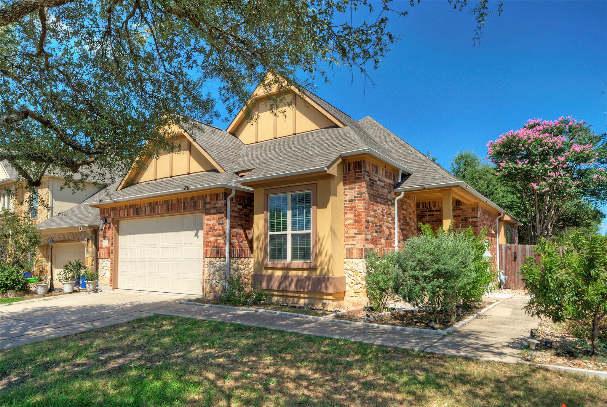 A classic brick exterior and manicured landscapin