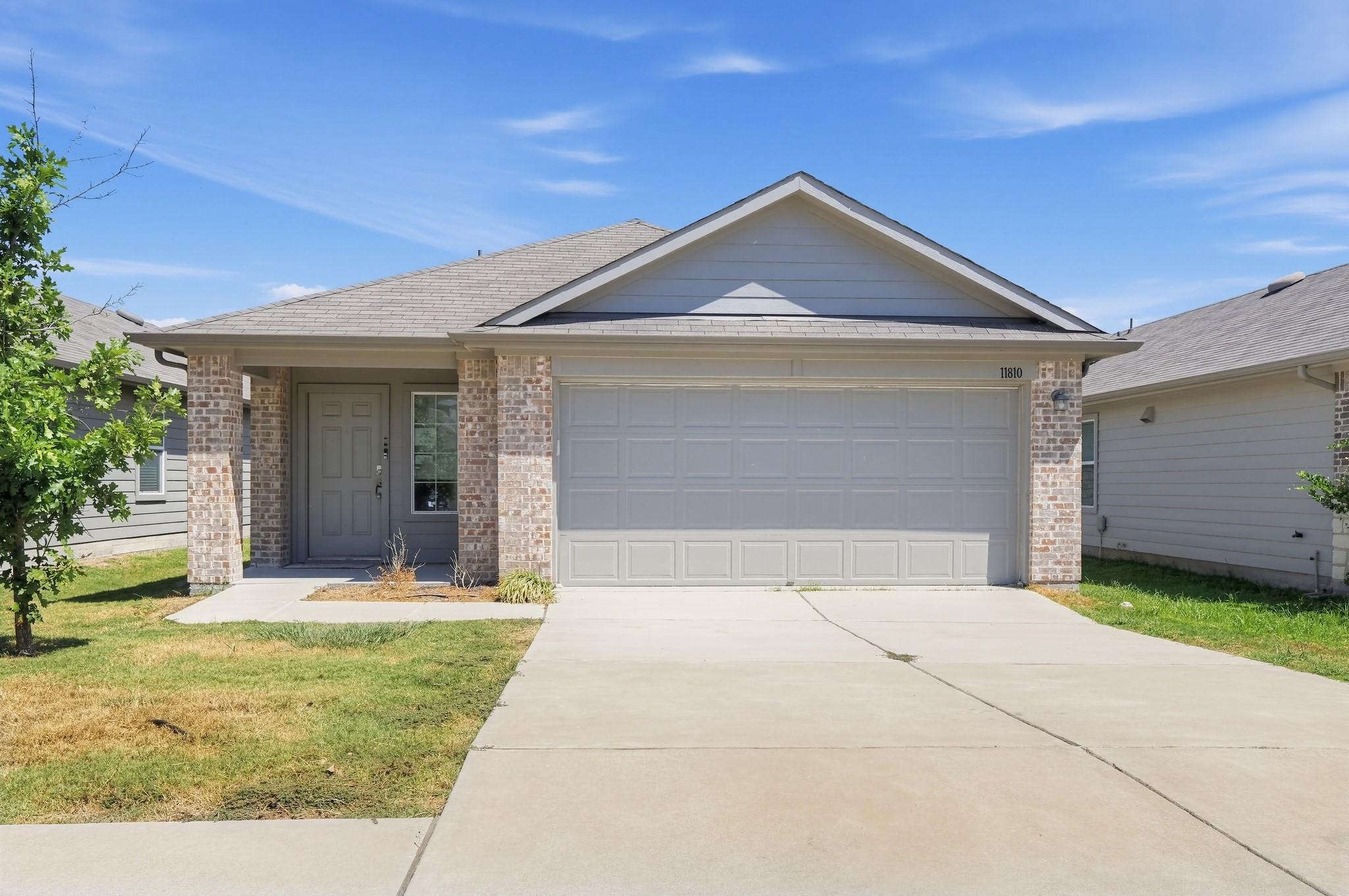 Brick accents and a classic gabled roofline defin