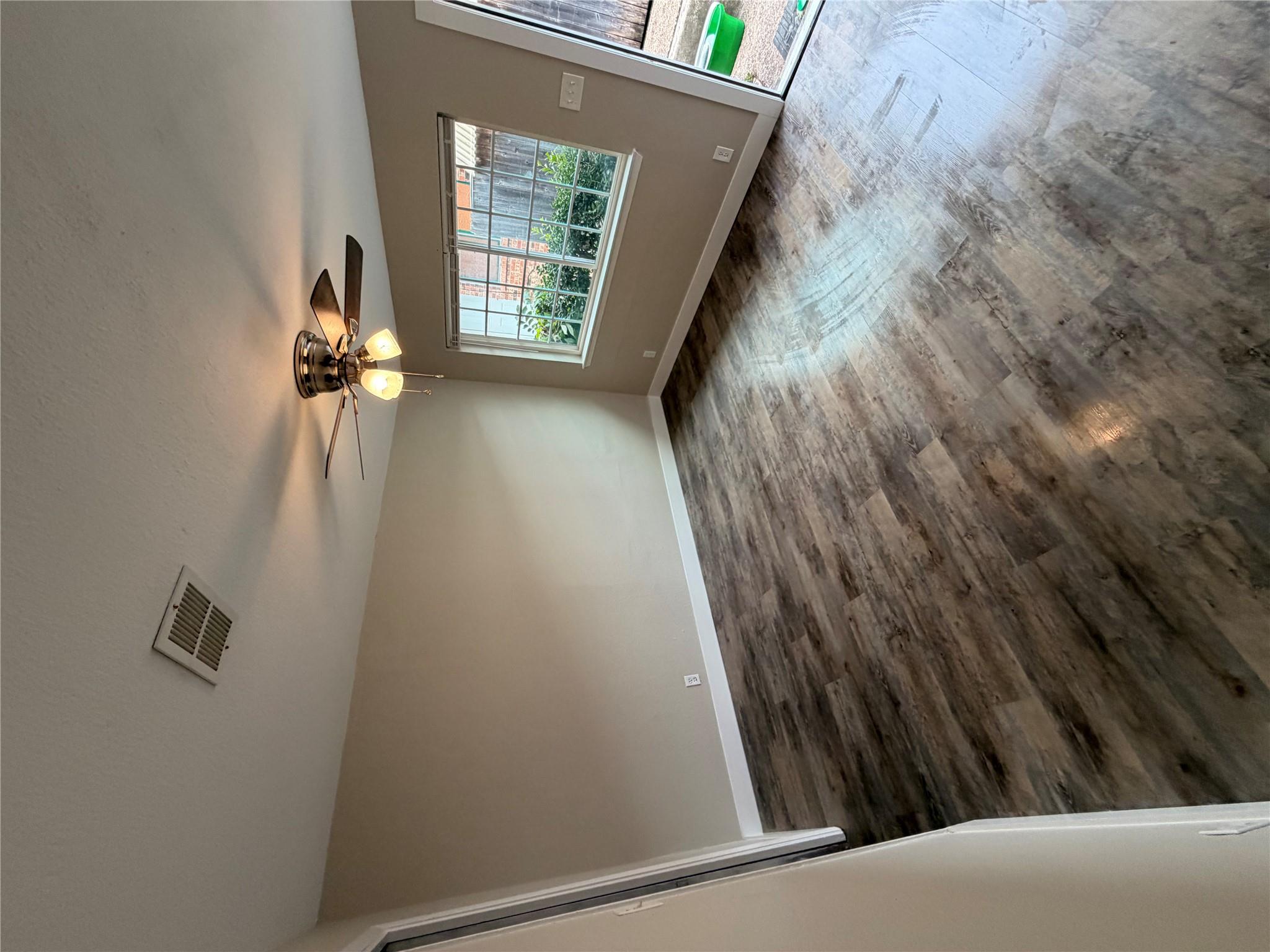 Gleaming wood-look floors anchor this versatile r