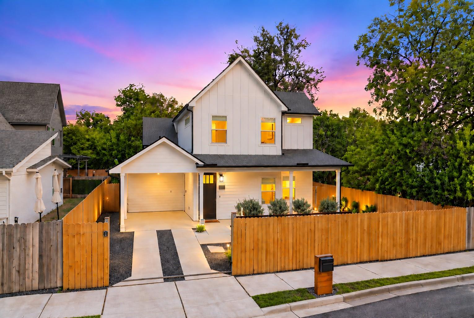 Modern vertical siding and a neat wood fence defi