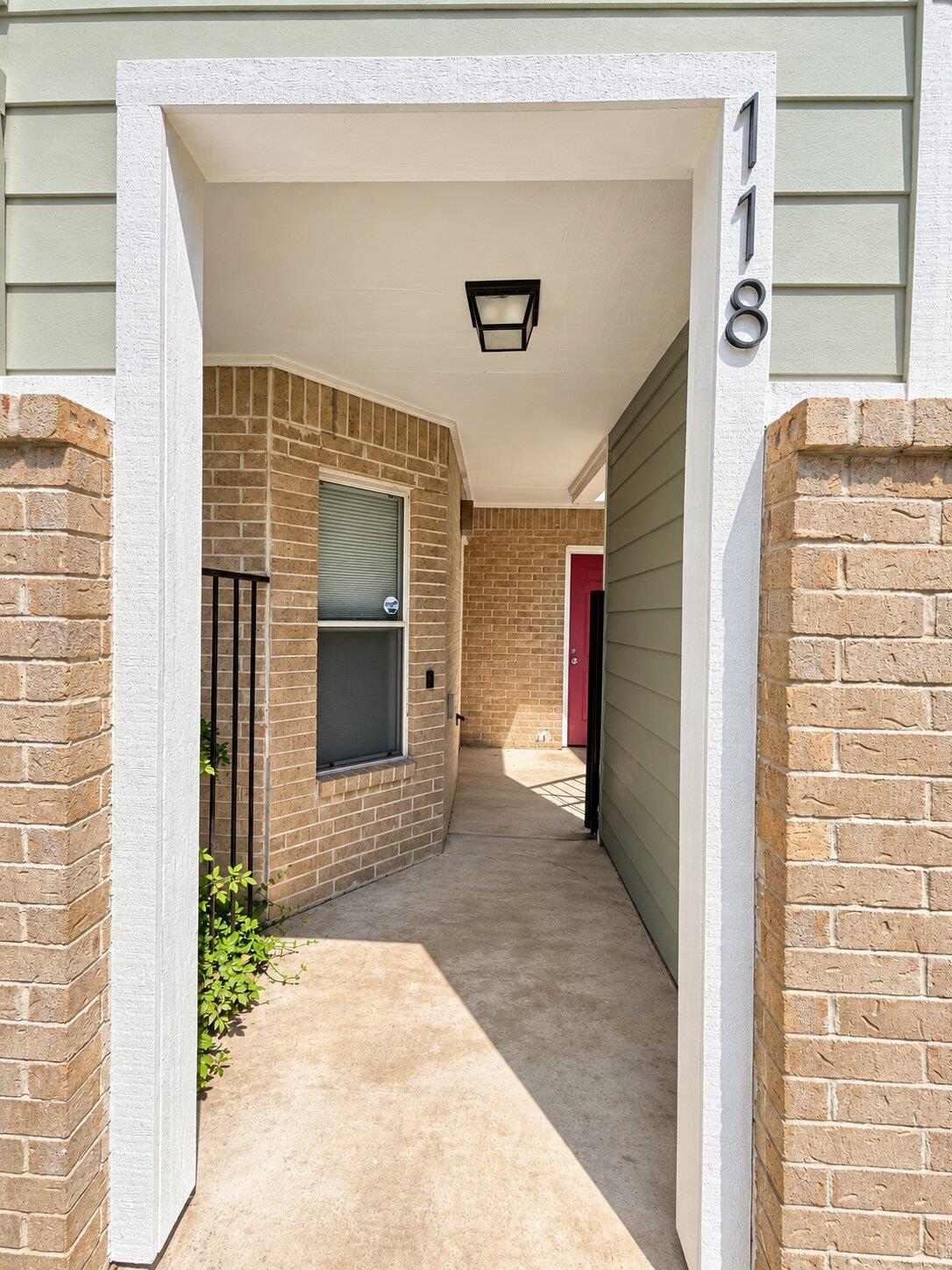 A welcoming covered entry walkway features a mix 