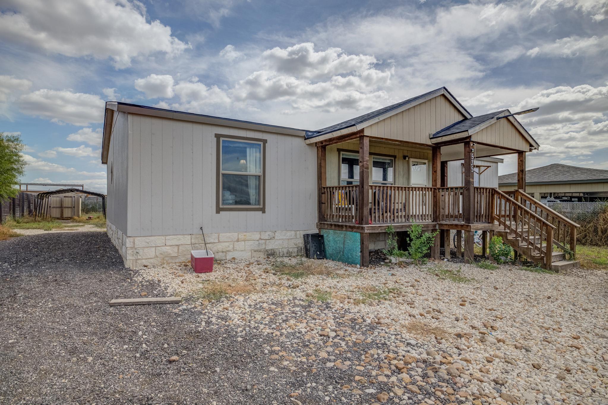 An inviting covered front porch with wooden raili