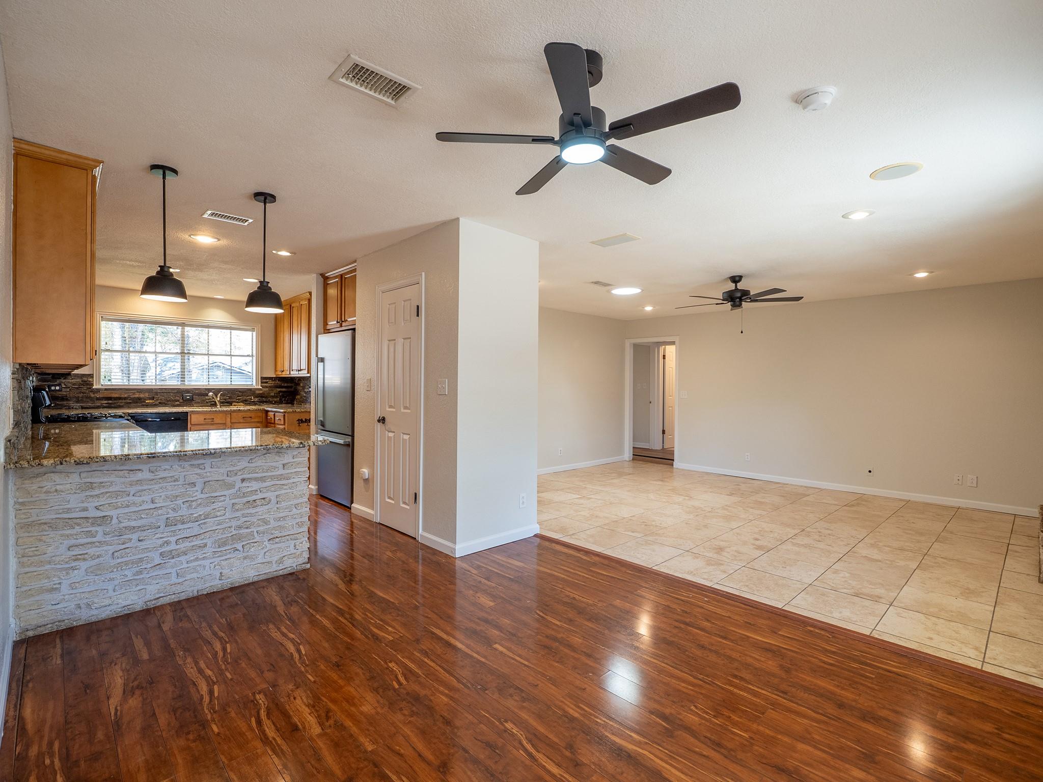 Rich hardwood floors transition seamlessly into a