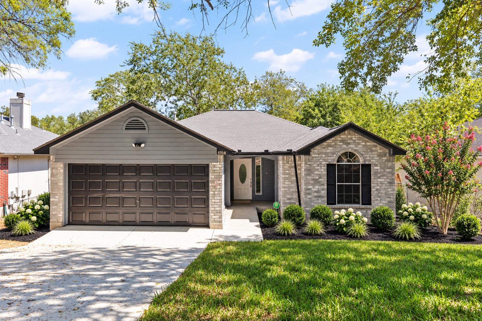 A classic brick and siding exterior stands surrou