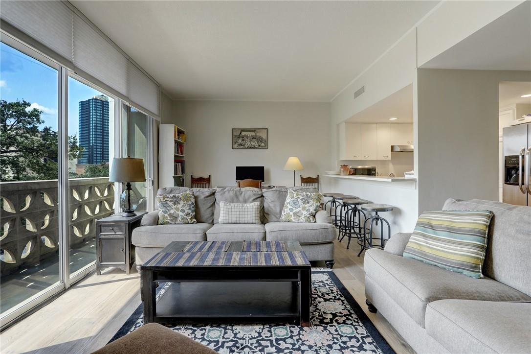 Floor-to-ceiling glass doors open to a private ba