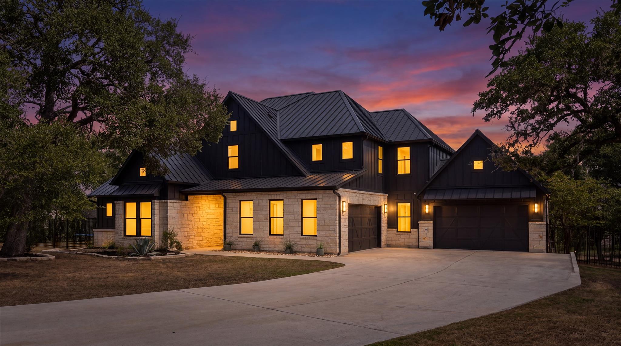 Dramatic dark siding and native stone masonry cre