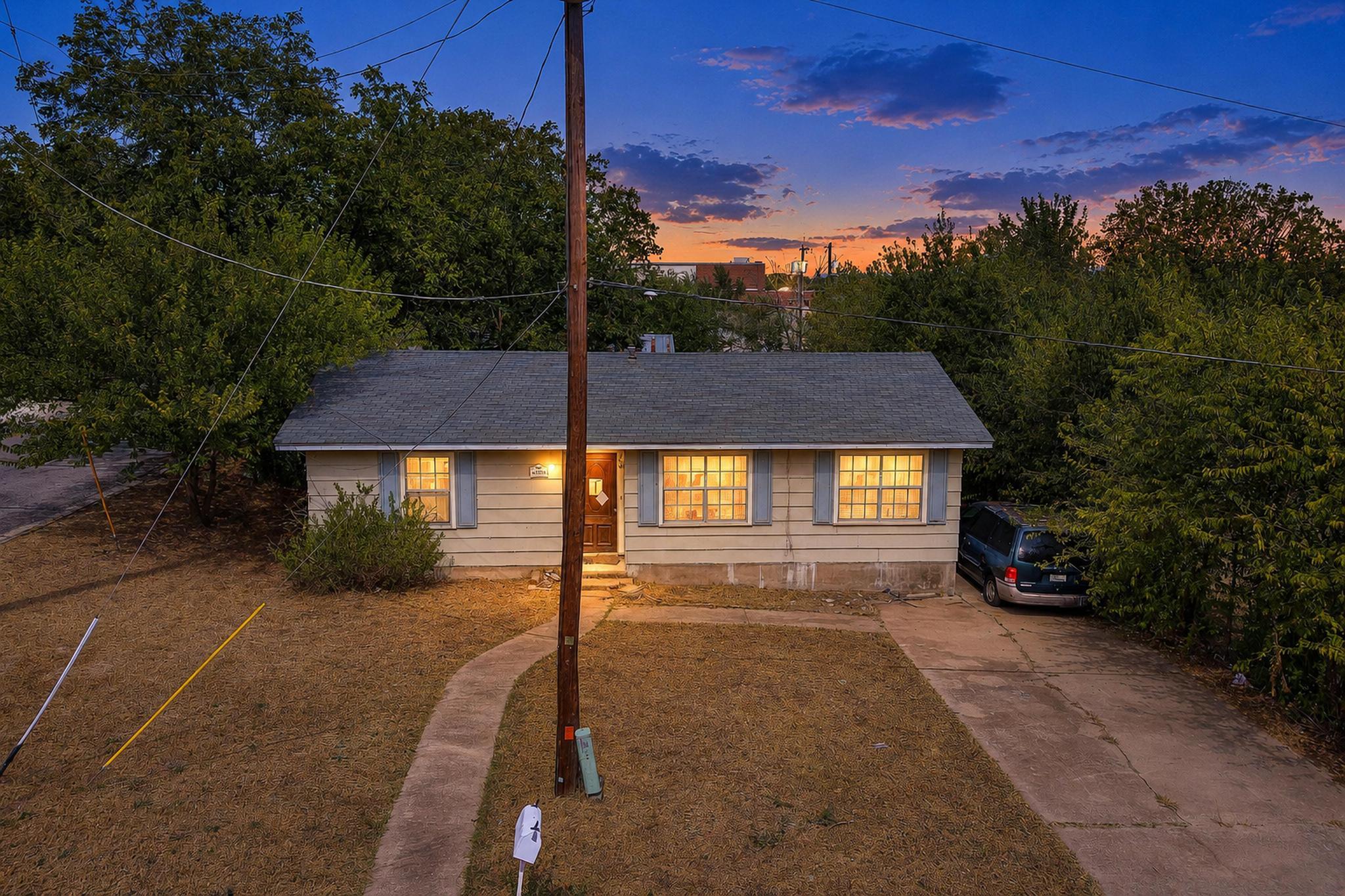 Mature trees frame a classic single-story exterio