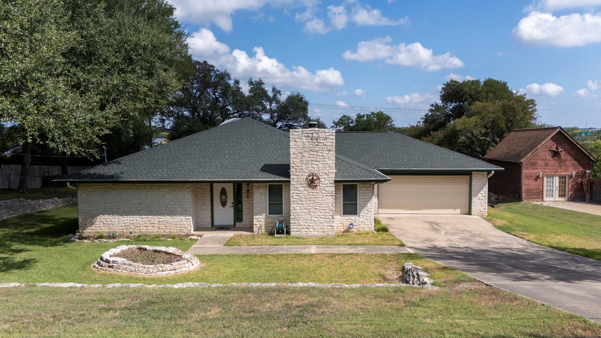 Classic stone masonry pairs with a tidy lawn and 