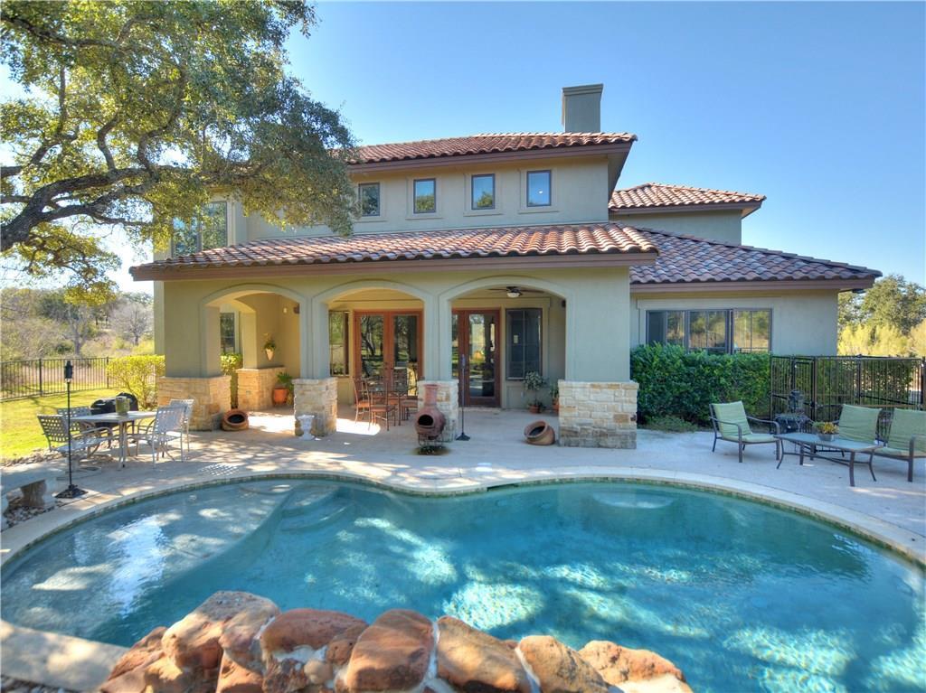 A sparkling in-ground pool fronts this Mediterran