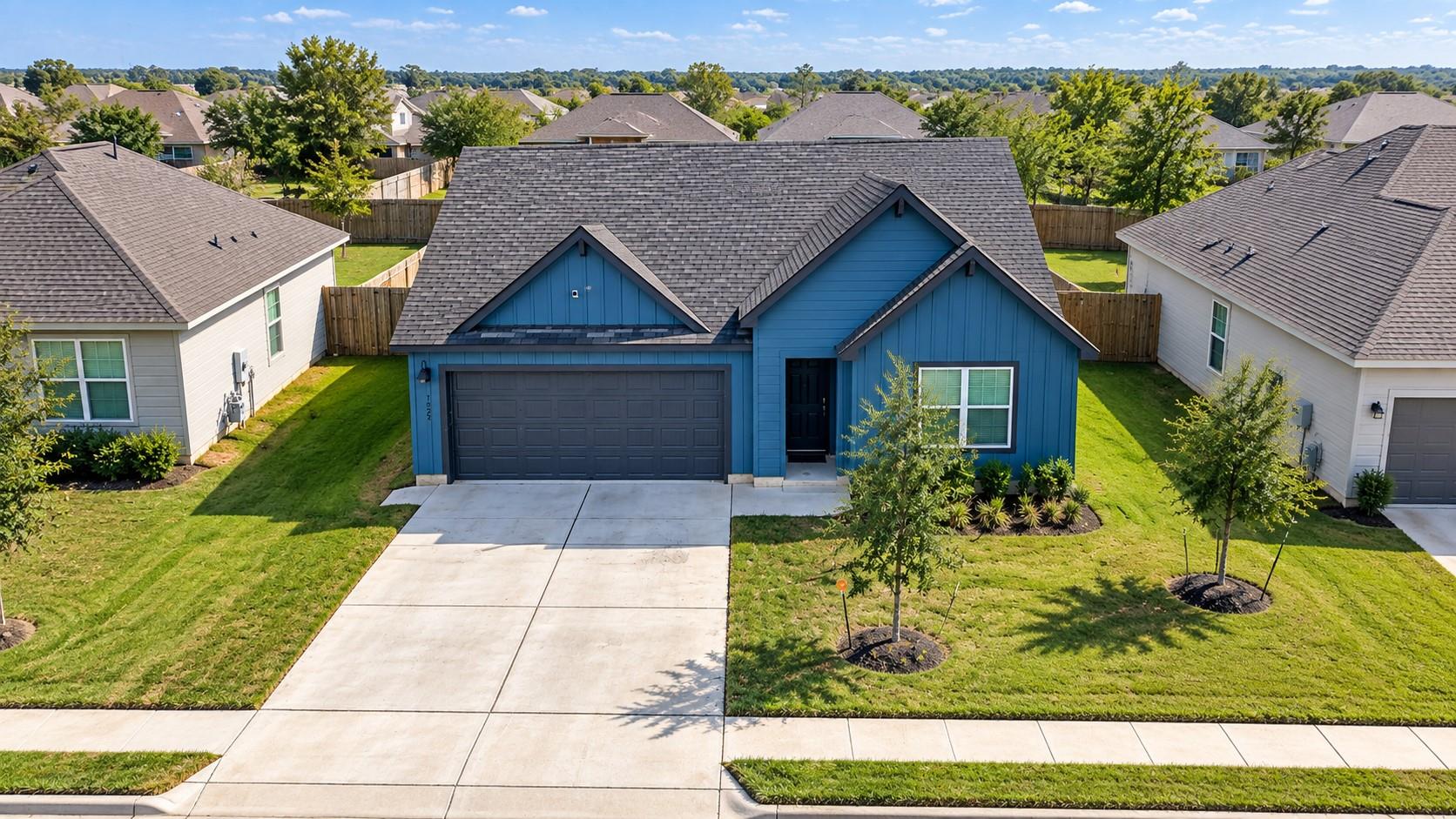 Bold blue siding and prominent gables define this