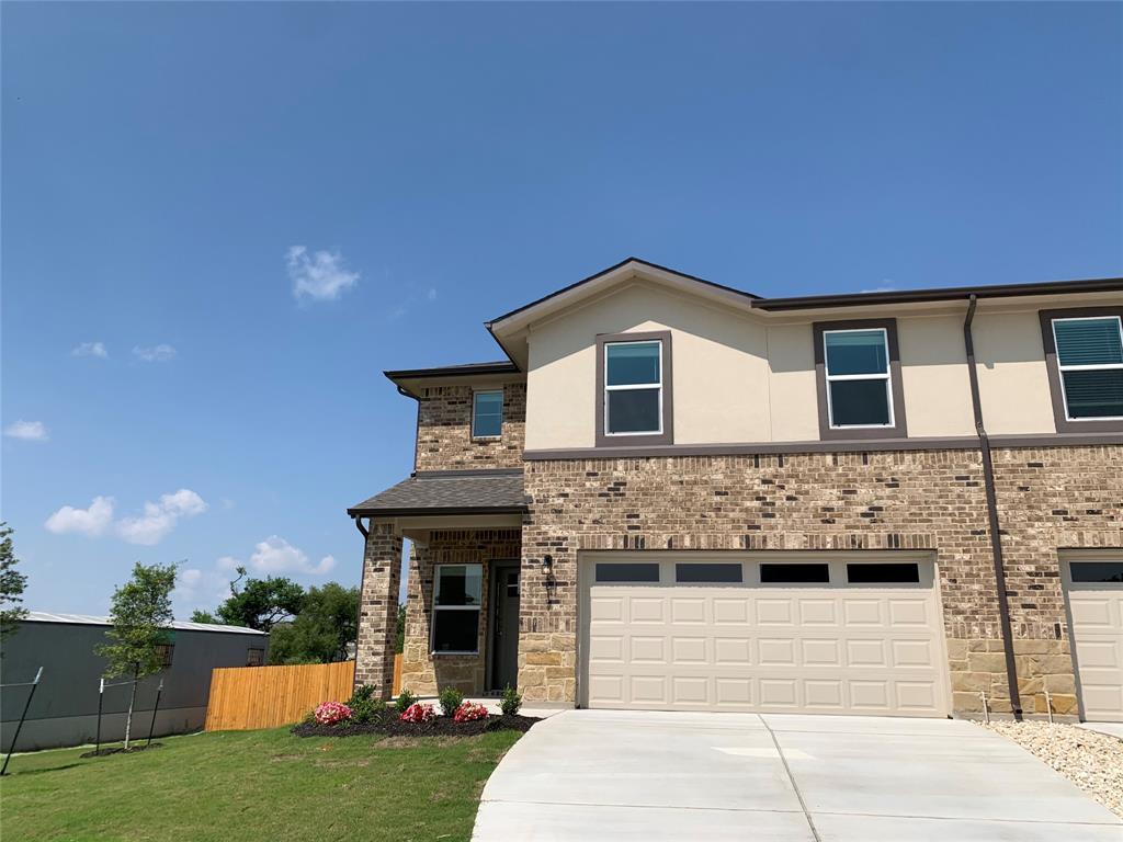 An inviting stone and brick facade frames this tw