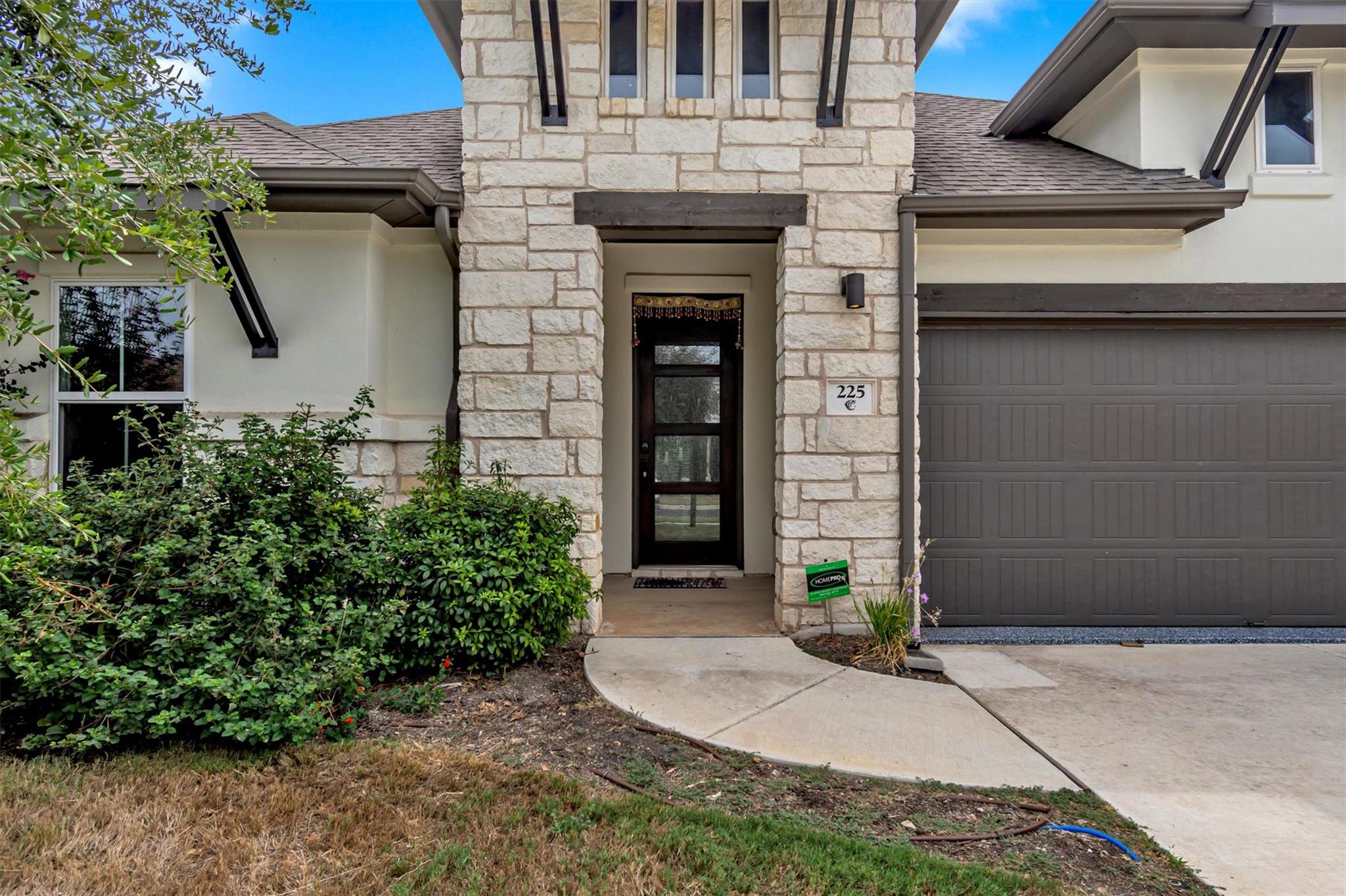 Natural stone masonry accents a welcoming recesse
