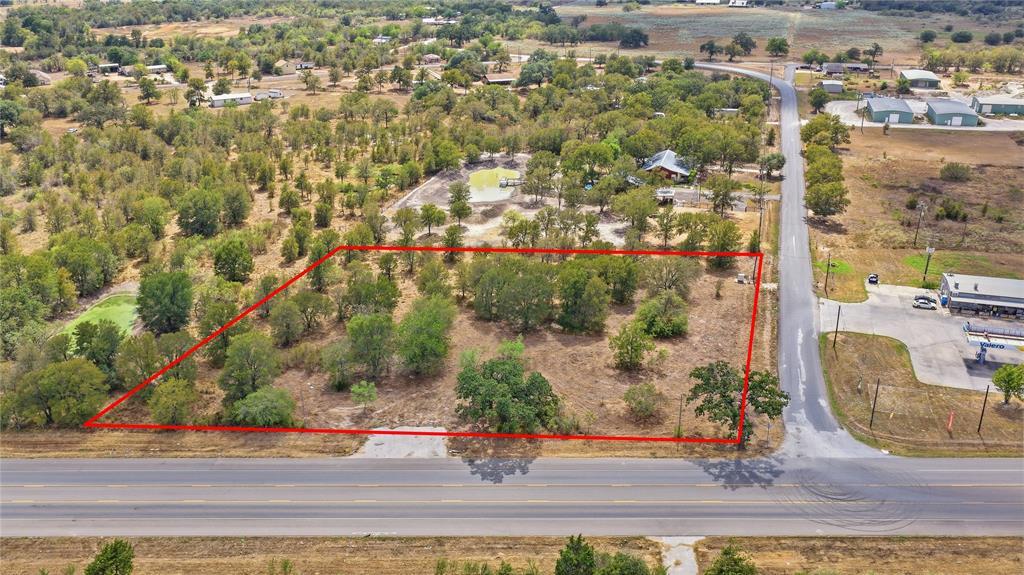 Mature trees dot this level property bordered by 