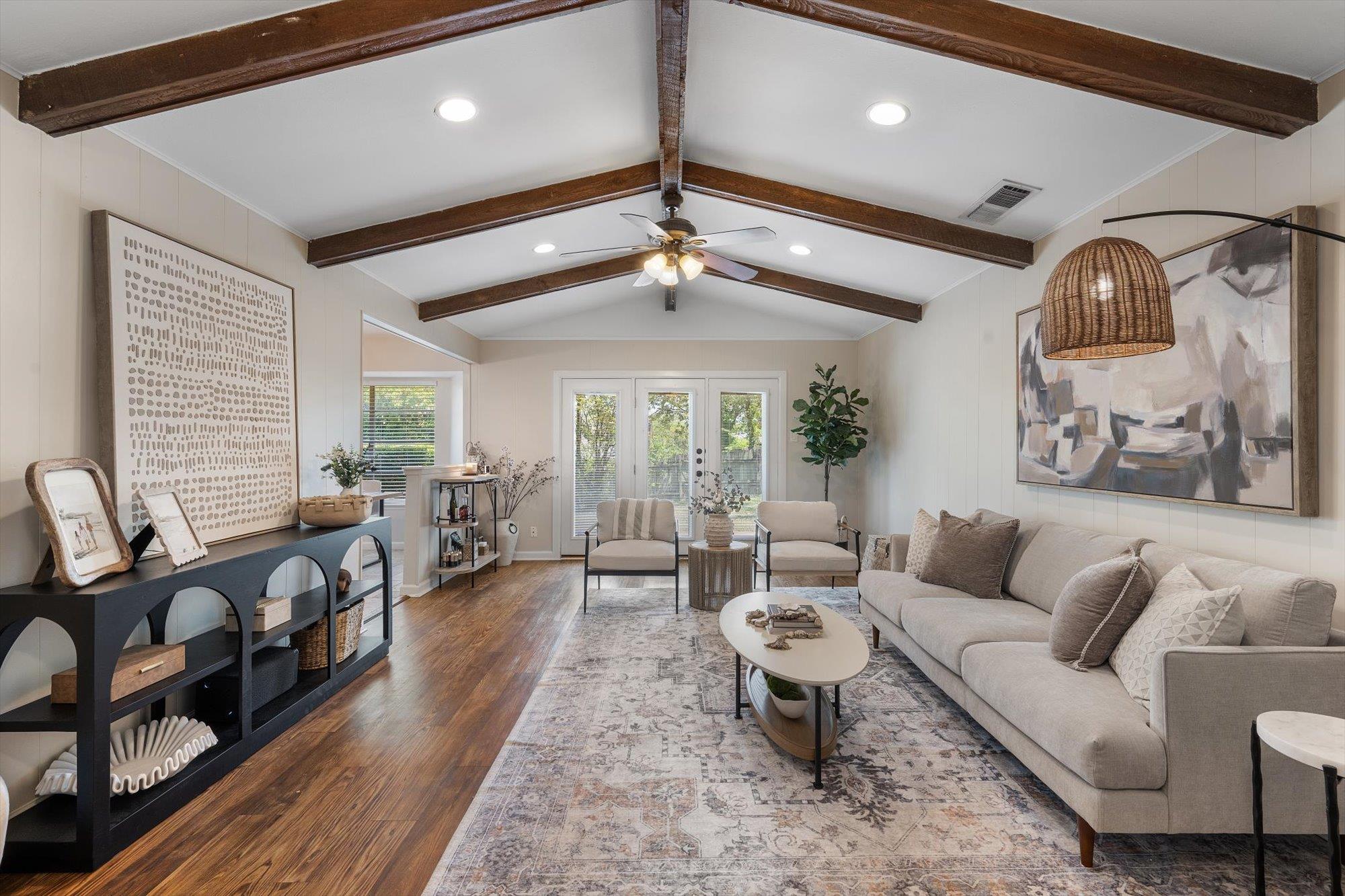 Rich exposed ceiling beams and warm wood flooring