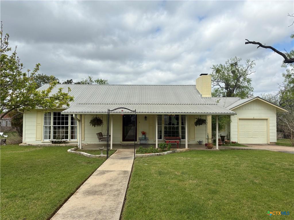 A classic front porch welcomes visitors under a d