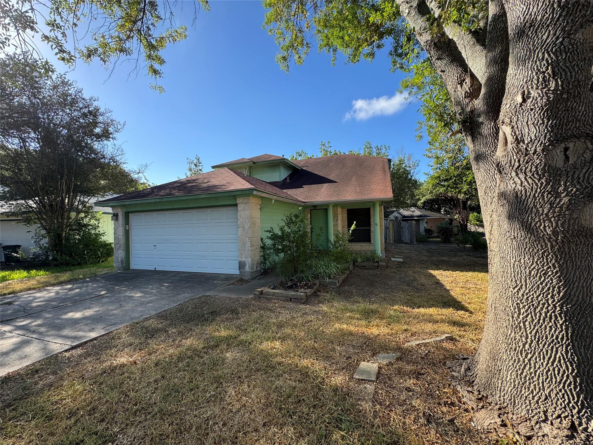 Mature trees shade the front lawn of this two-sto