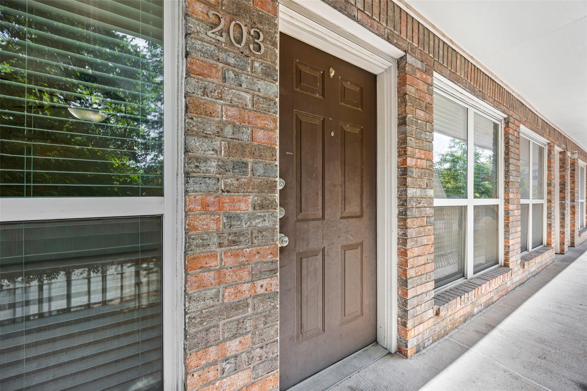 Brick cladding and large windows frame the covere