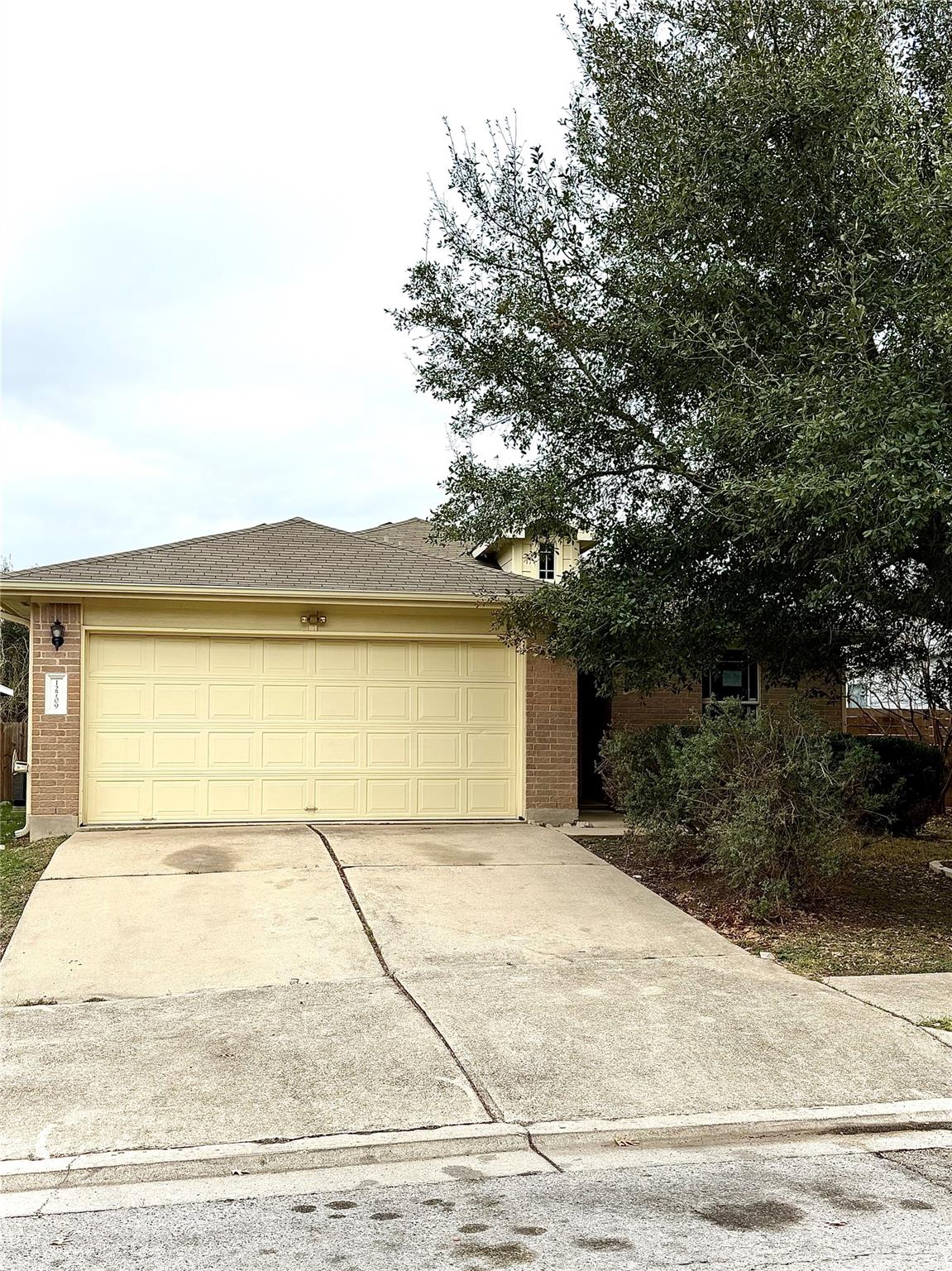 Mature trees shade the front entrance and spaciou