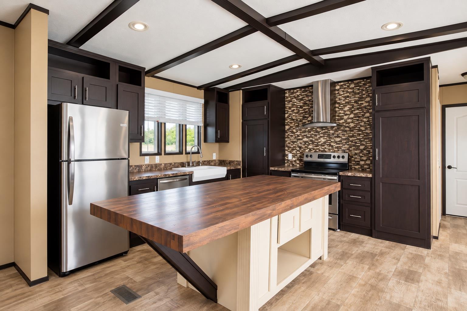 Rich wood ceilings and a massive center island de