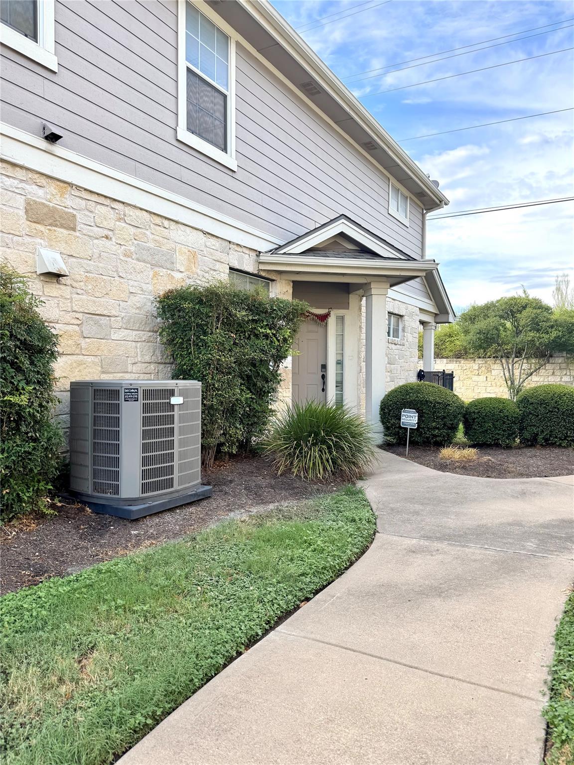 An inviting stone and siding entryway is approach