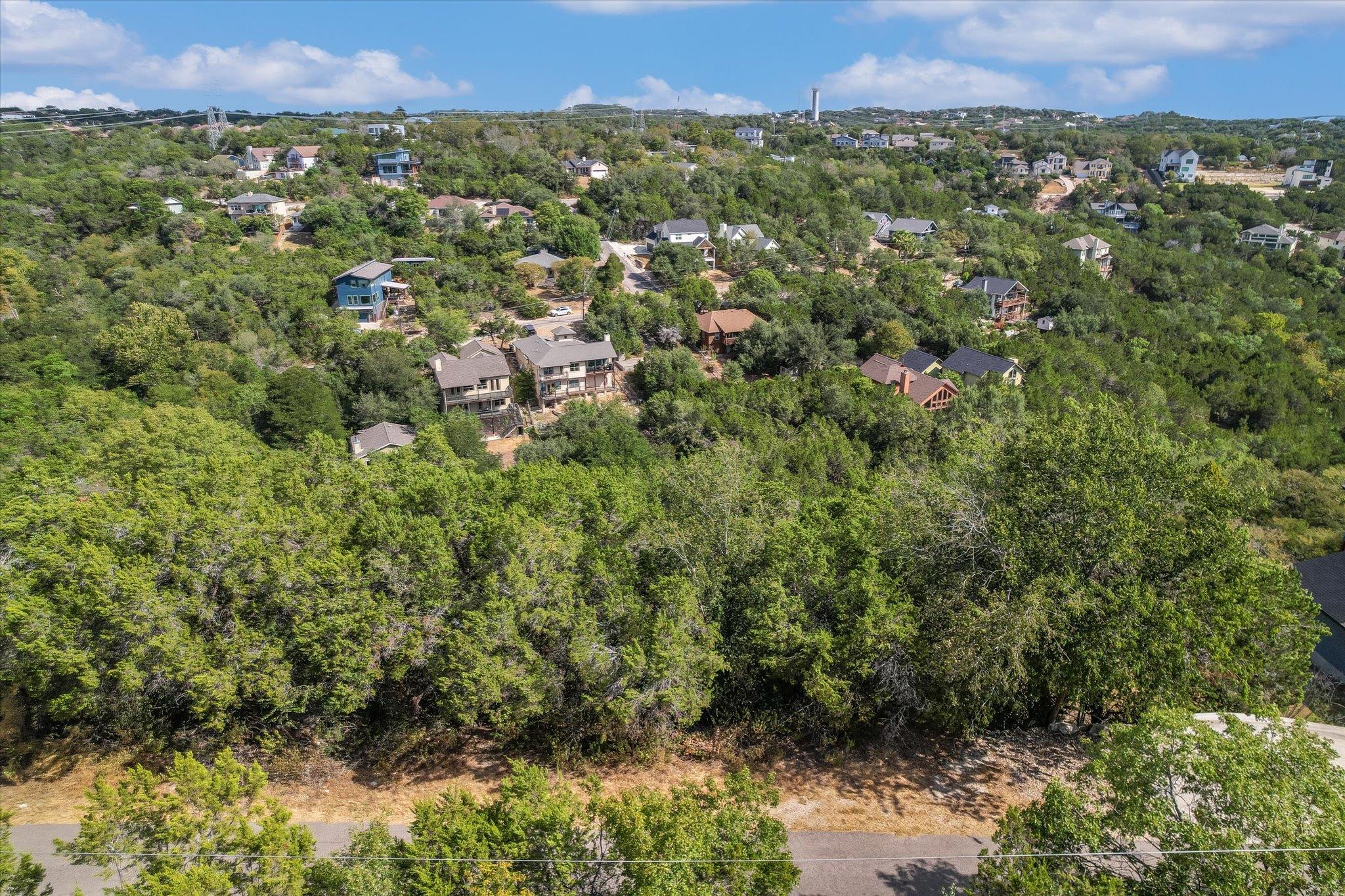 Lush green hillsides and scattered residential pr