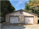 A detached stone garage provides secure parking a