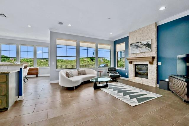 Tiled flooring and a stone-clad fireplace anchor 