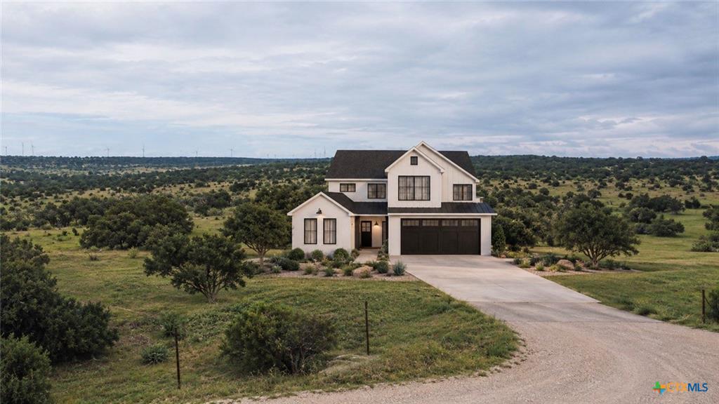 An inviting two-story farmhouse design features c