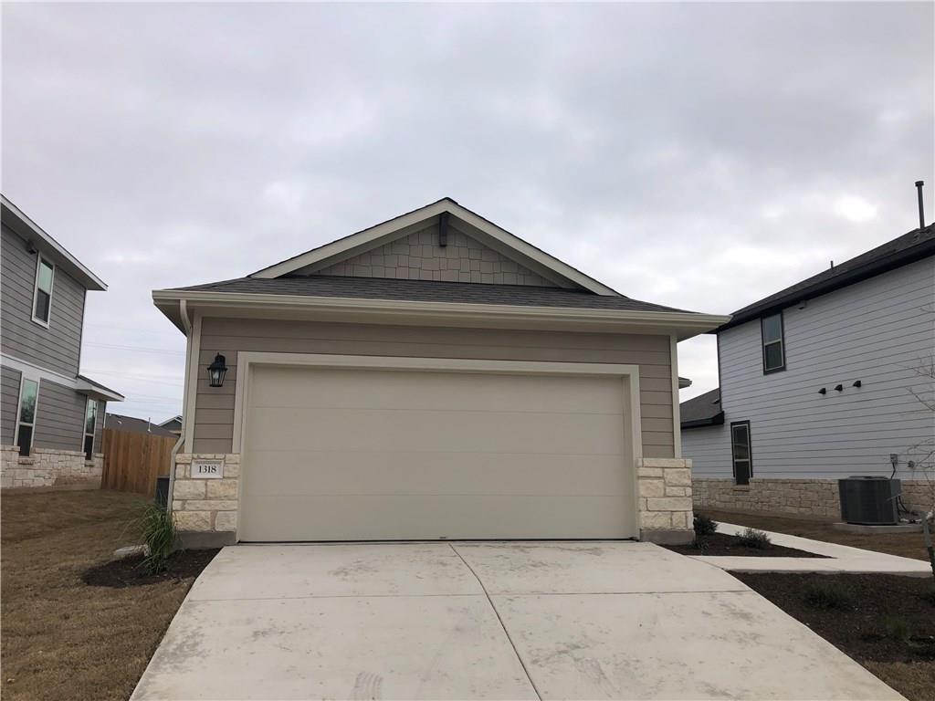 A spacious concrete driveway leads directly to a 