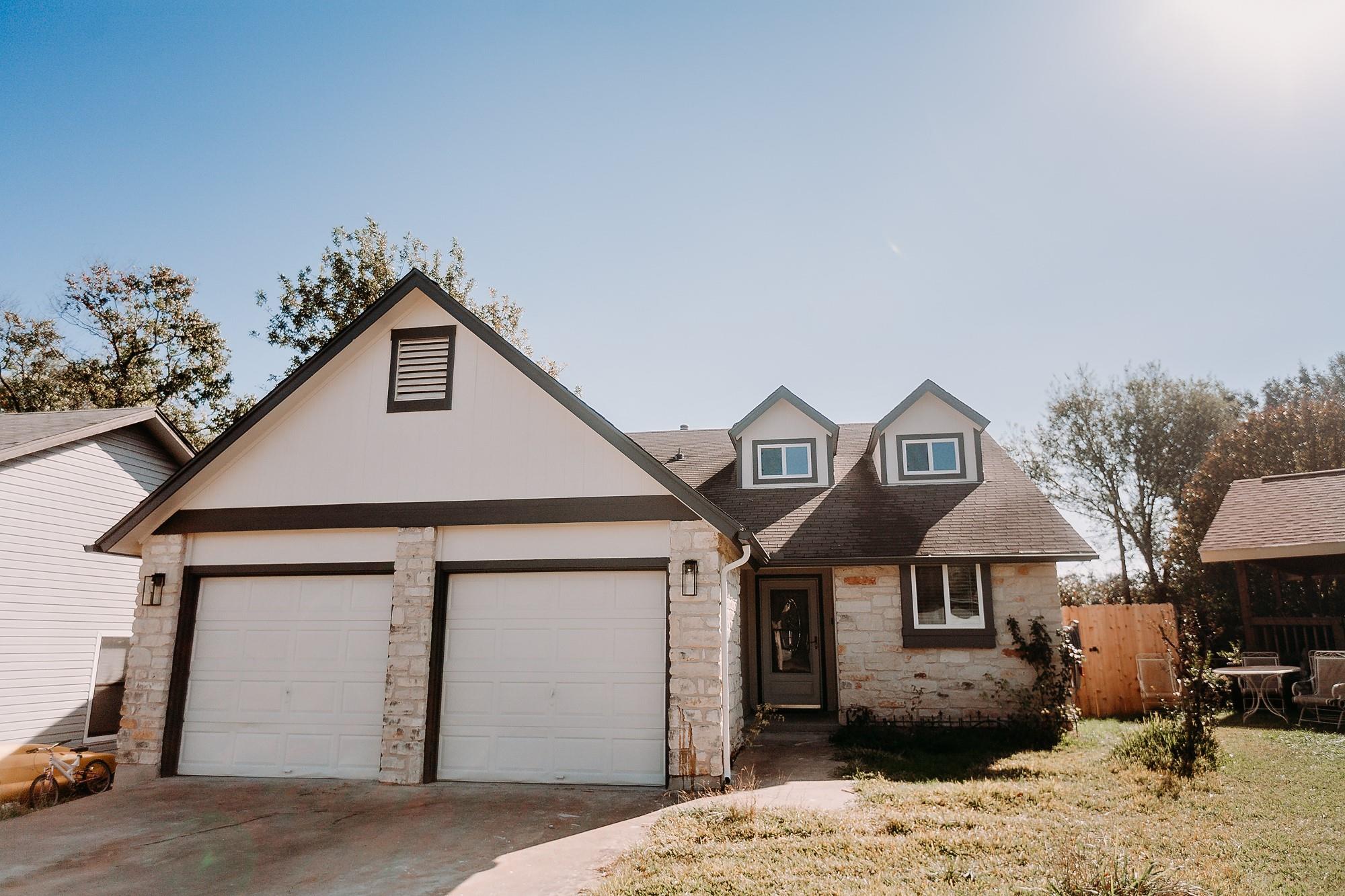 Limestone masonry accents and twin dormer windows