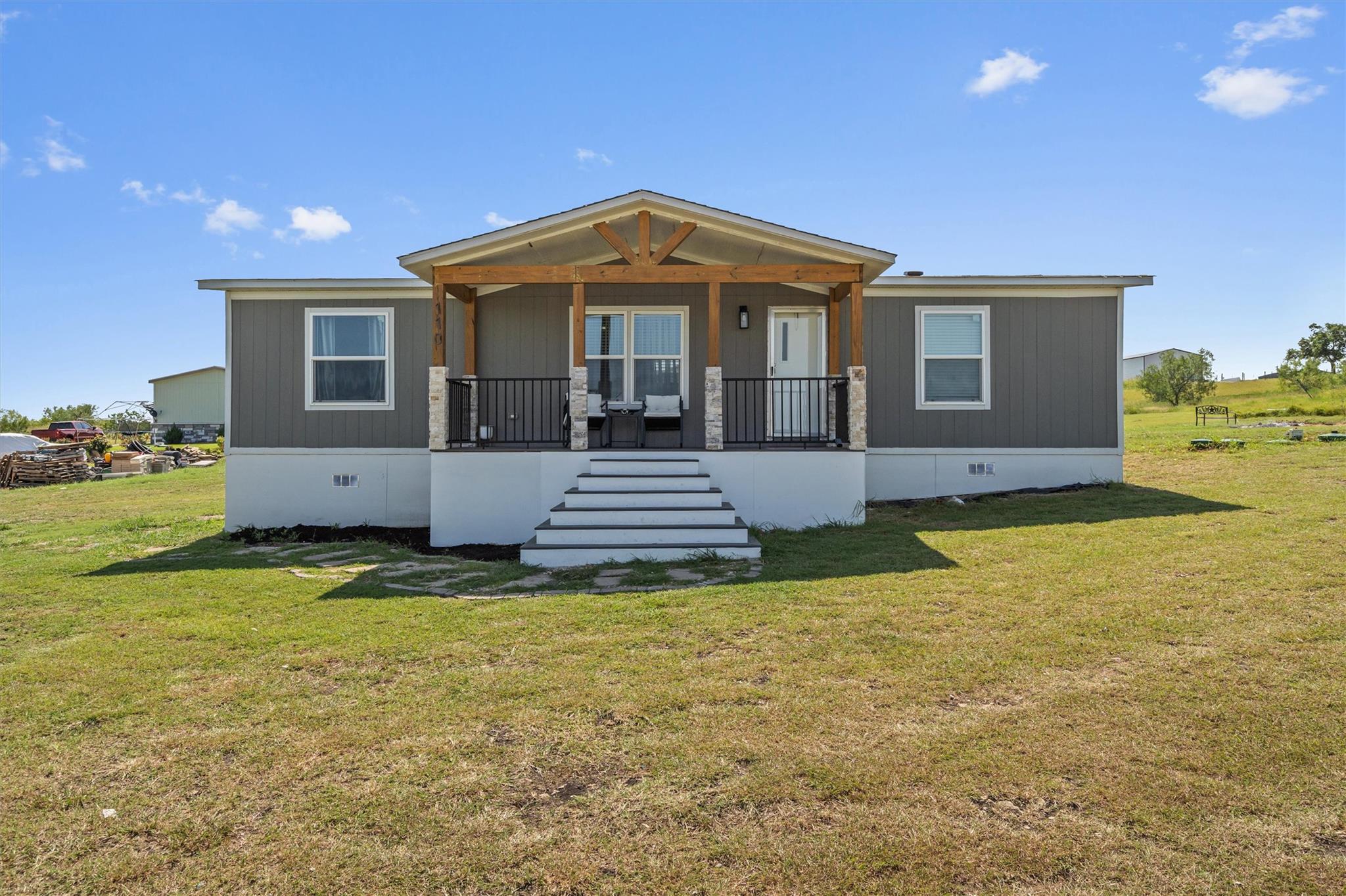 Welcoming front porch with timber framing enhance