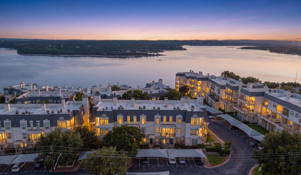 Dusk falls over a multi-level lakeside community 