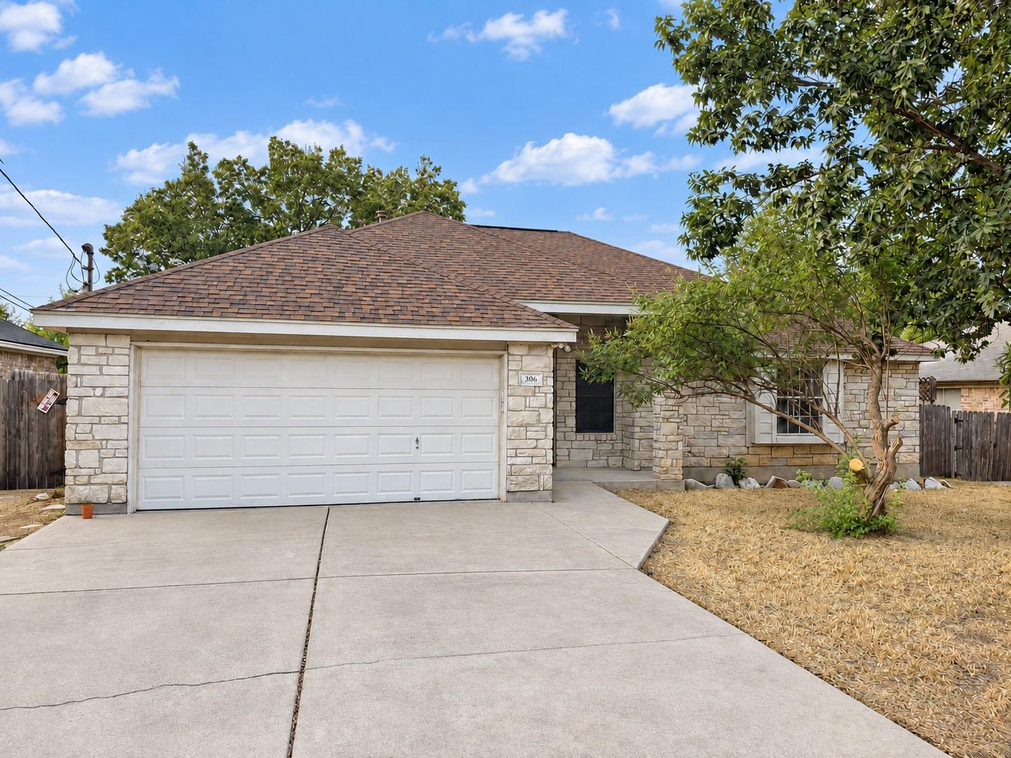A classic stone exterior and spacious driveway de