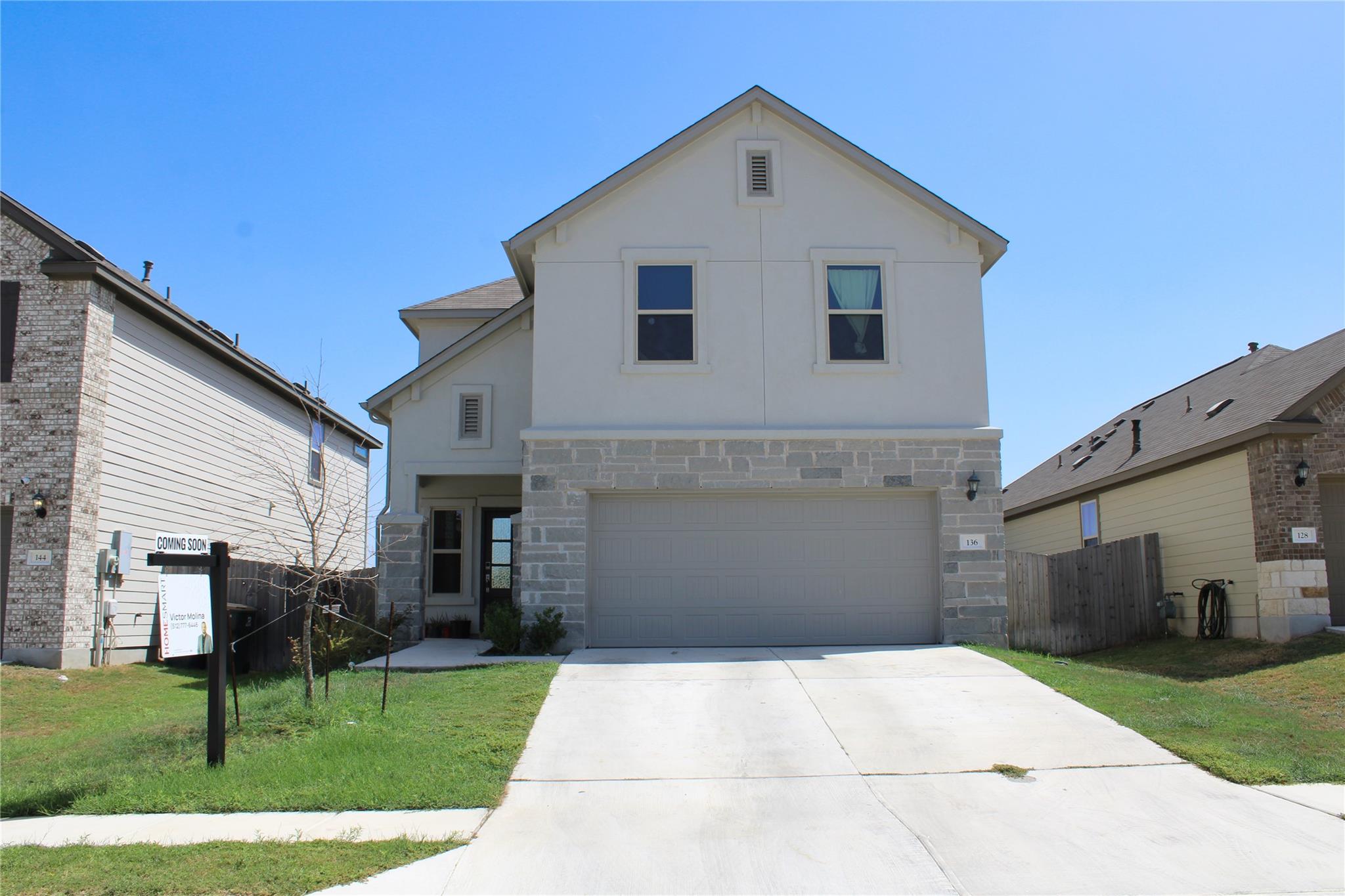 A spacious driveway leads directly to the two-car