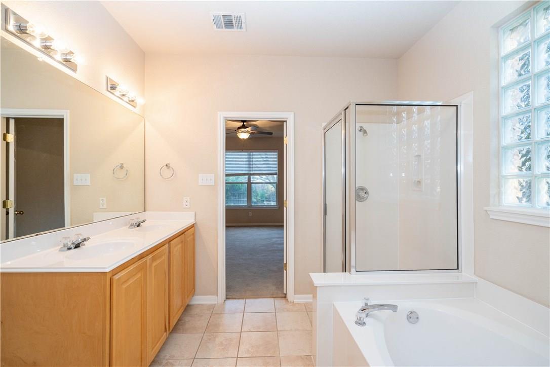 Tile flooring and a separate walk-in shower eleva