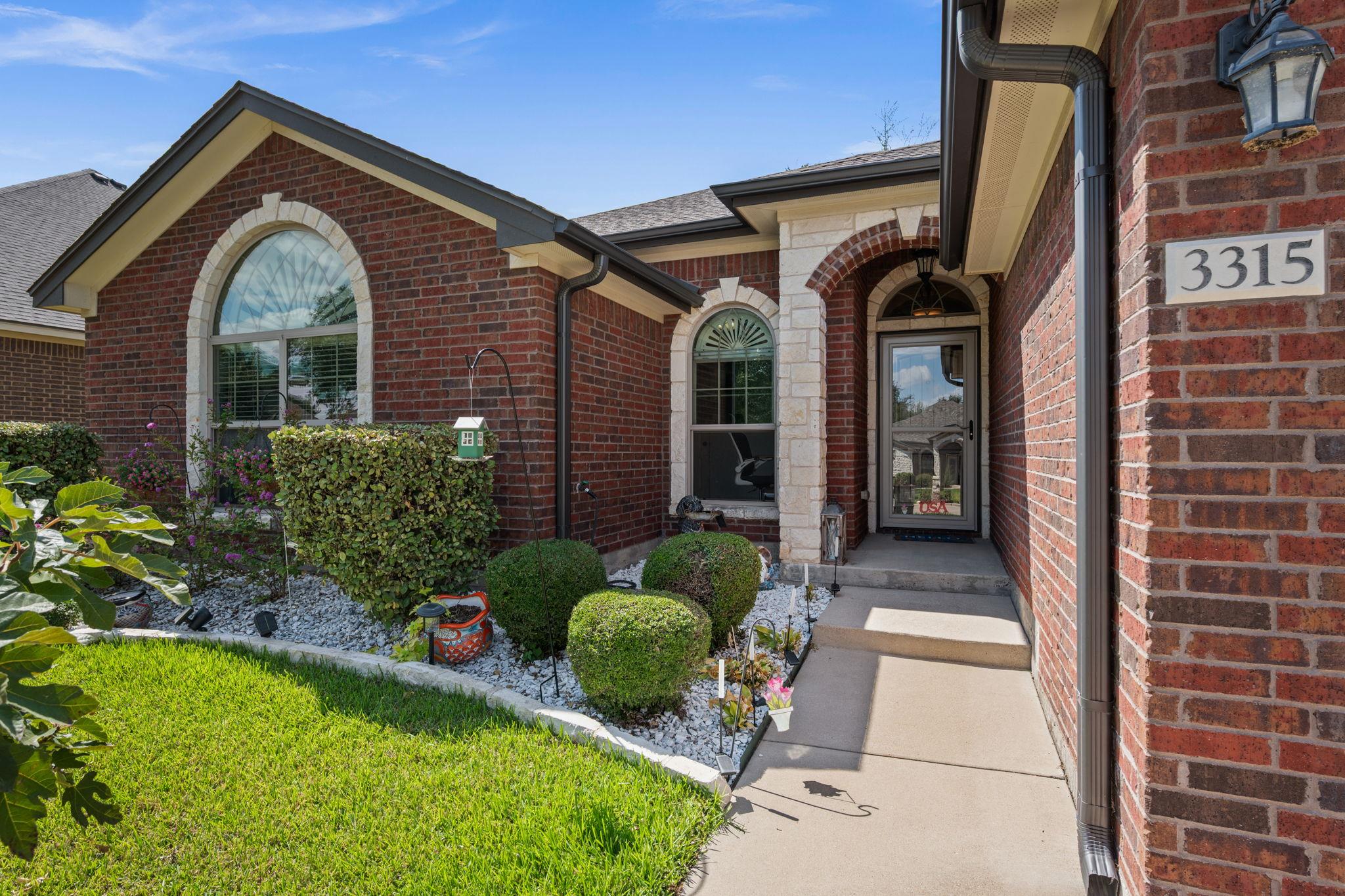 Brick and stone accents highlight the classic arc