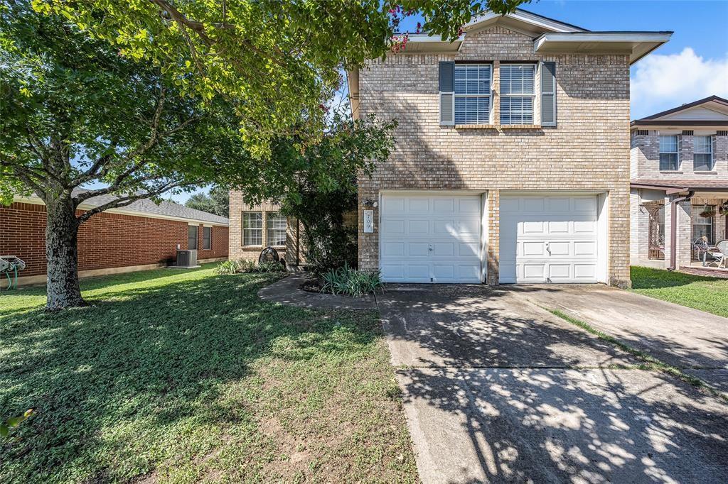 A two-story brick exterior is complemented by an 