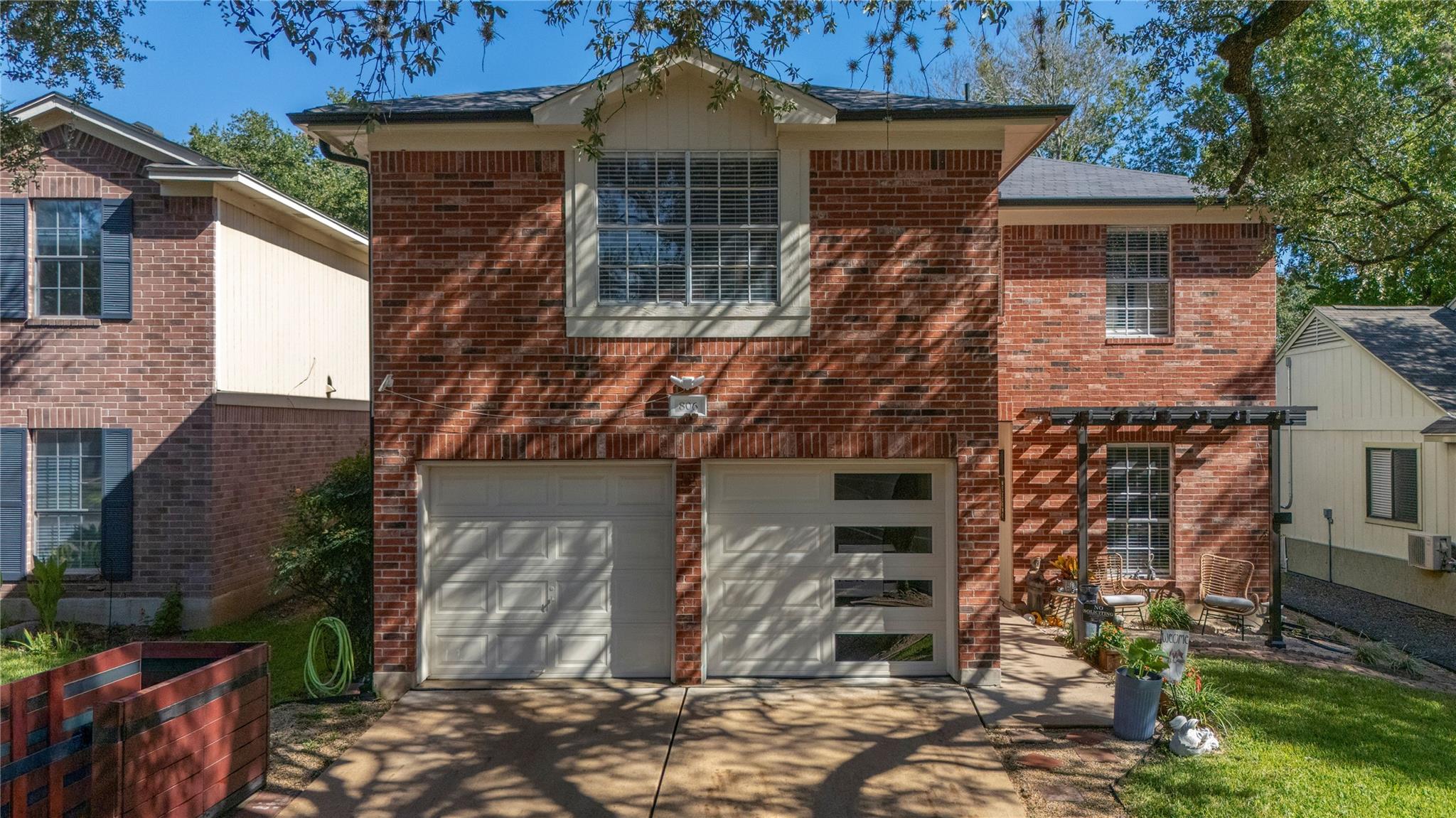 A classic brick exterior surrounds the two-car ga
